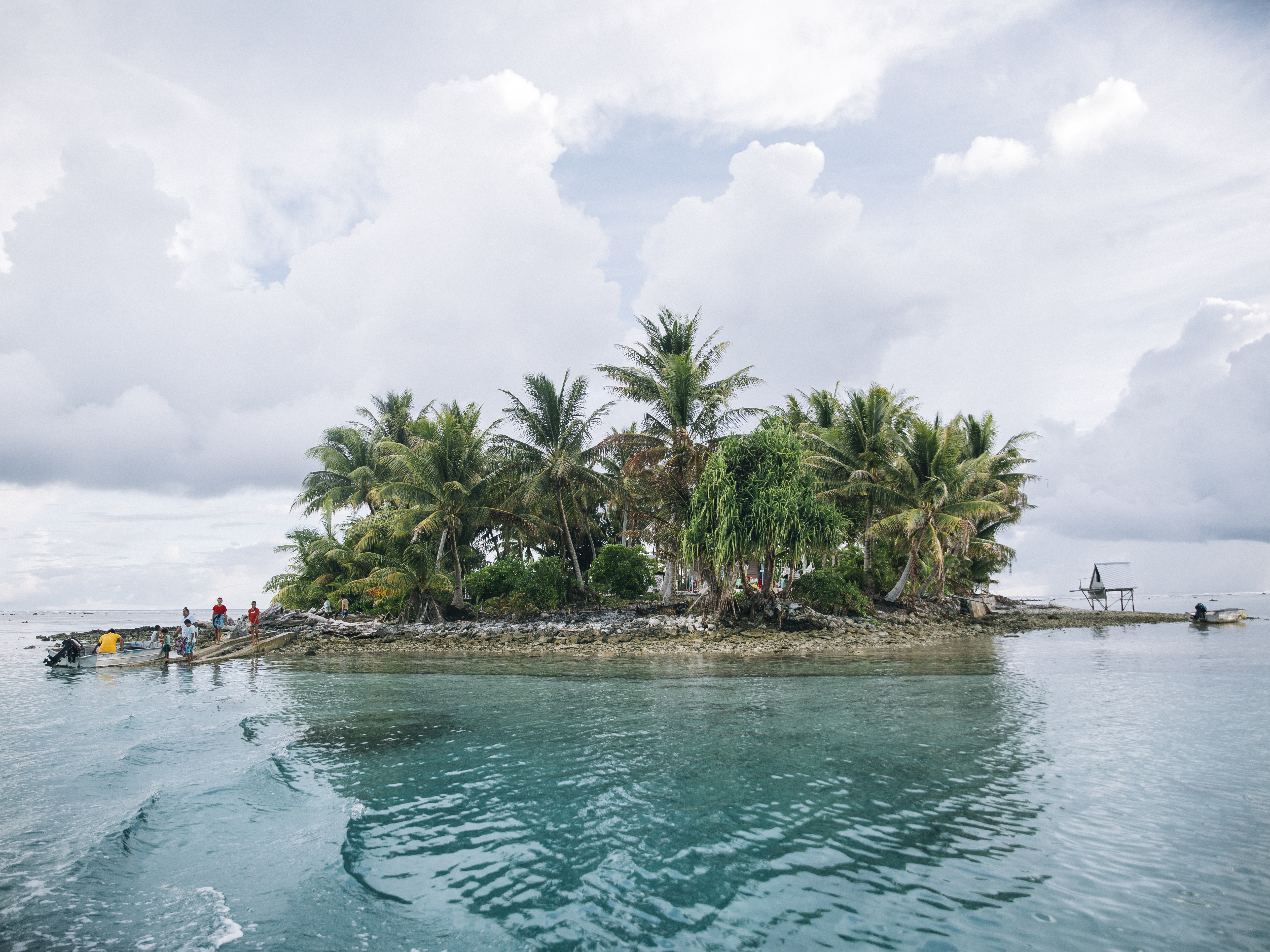 caption: Teafua Tanu is an islet of Tokelau used by residents of Fakaofo atoll as a Catholic cemetery. Over the past two decades, the territory of Tokelau has proved extremely vulnerable to climate change and rising sea levels owing, partly, to its being a small land mass surrounded by ocean, and its location in a region prone to natural disasters.