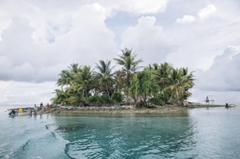 caption: Teafua Tanu is an islet of Tokelau used by residents of Fakaofo atoll as a Catholic cemetery. Over the past two decades, the territory of Tokelau has proved extremely vulnerable to climate change and rising sea levels owing, partly, to its being a small land mass surrounded by ocean, and its location in a region prone to natural disasters.