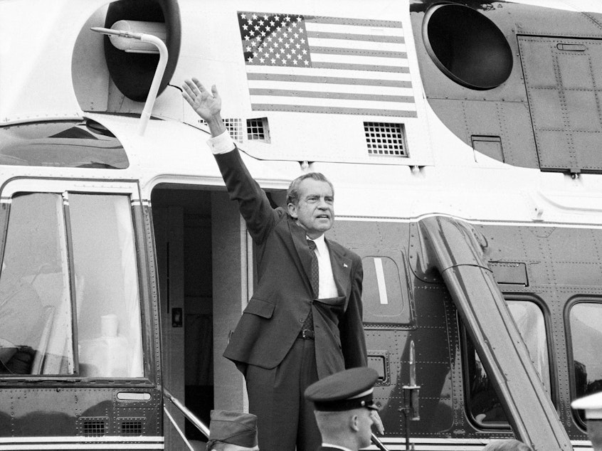 caption: President Nixon waves outside the White House after his farewell address Aug. 9, 1974.