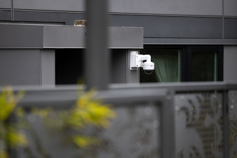 caption: Security camera are shown behind the Janus apartments along 85th street on Monday, December 19, 2022, in Seattle. 