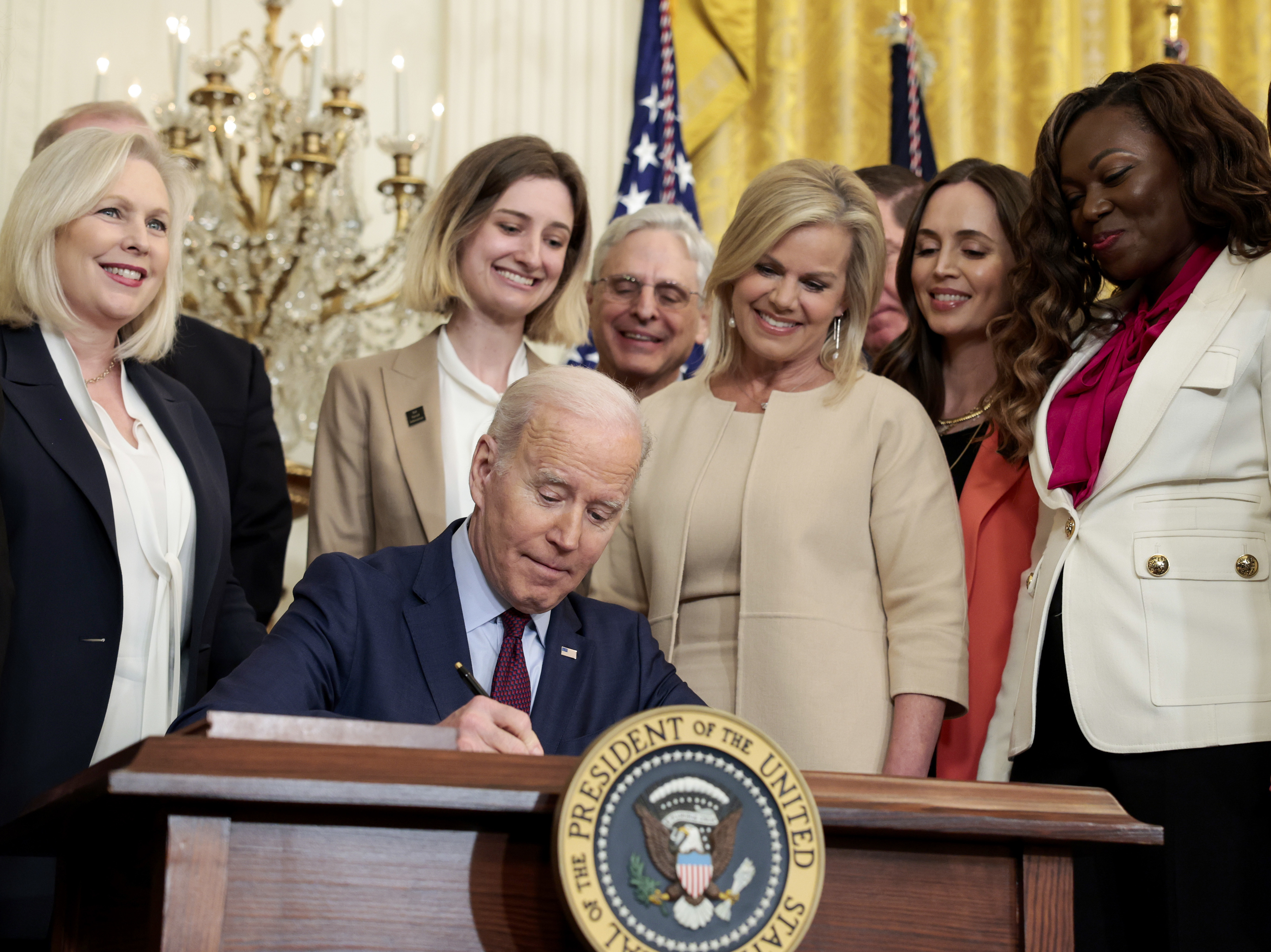 caption: President Joe Biden signs the Ending Forced Arbitration of Sexual Assault and Sexual Harassment Act of 2021 into law on Thursday.