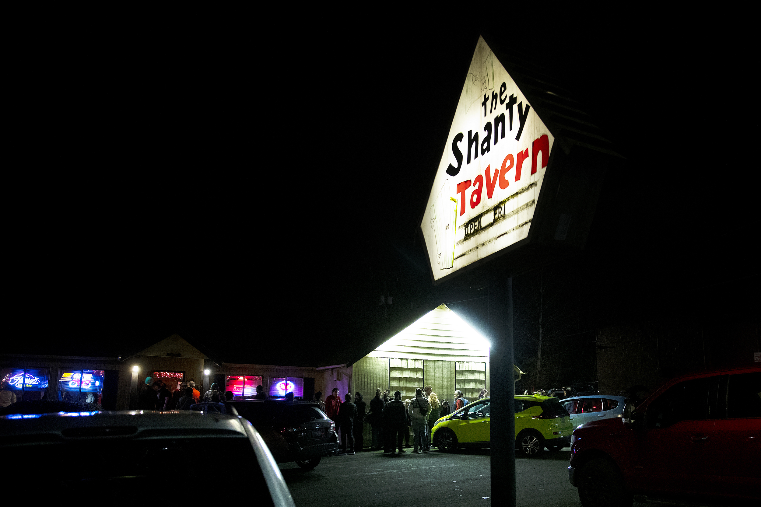 caption: A line forms outside of the Shanty Tavern in Lake City on Friday, December 19, 2025, on the last night of business for what many call the ‘last roadhouse in Seattle.’ 