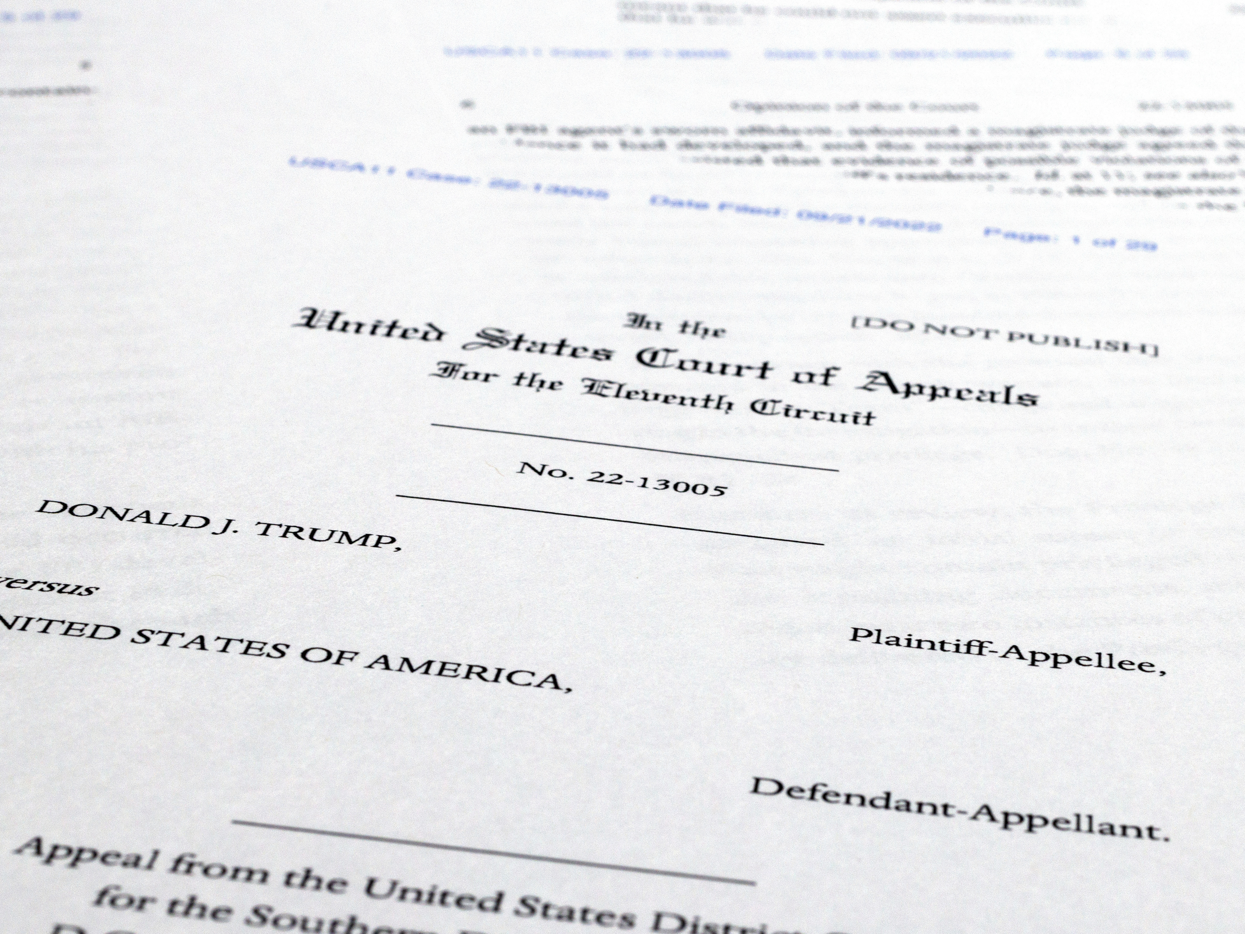 caption: Pages from a U.S. Court of Appeals for the 11th Circuit in Atlanta ruling that lifts a judge's hold on the Justice Department's ability to use classified documents seized by the FBI at Trump's Mar-a-Lago estate.