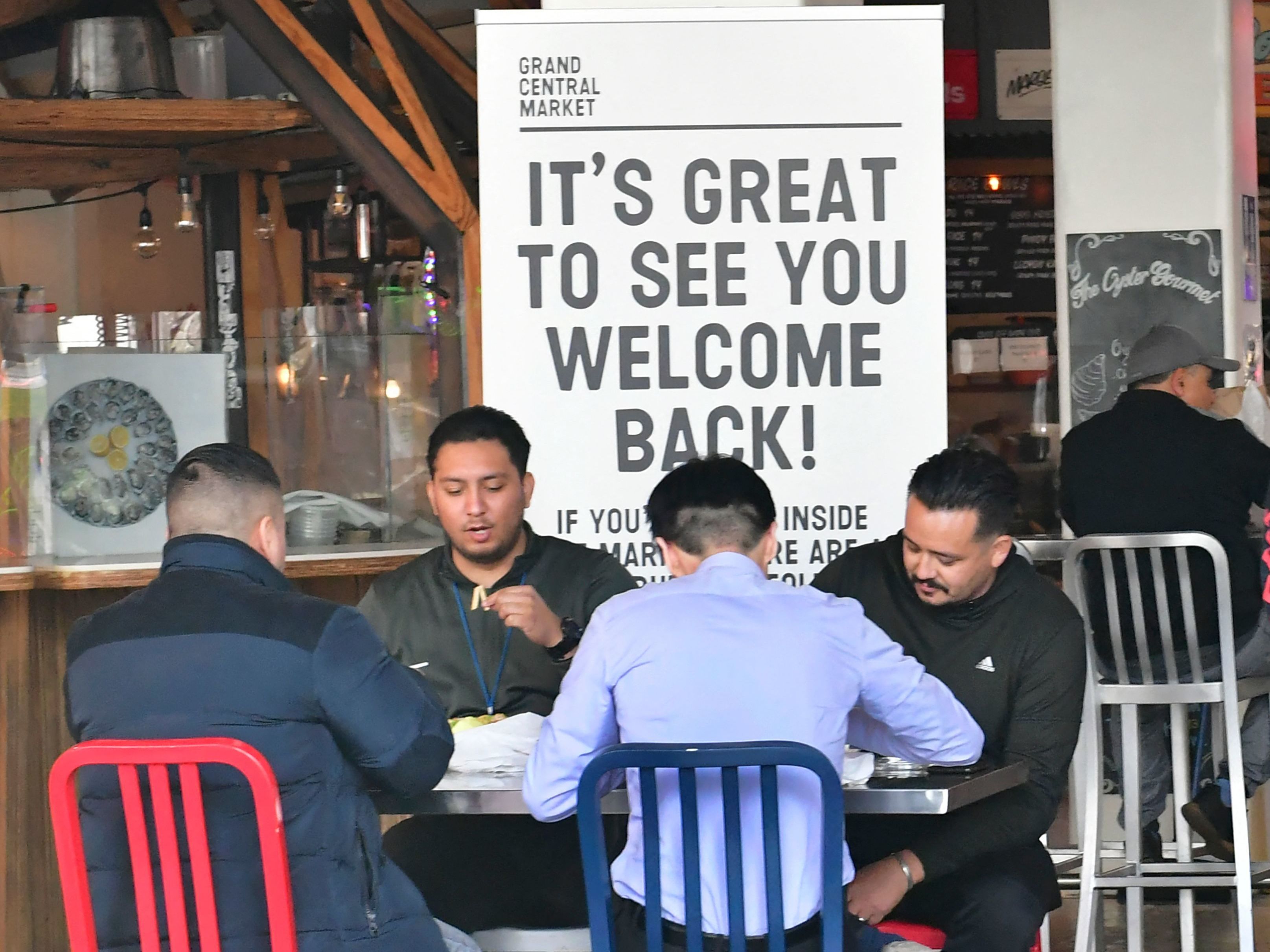 caption: People enjoy lunch at Grand Central Market as indoor dining reopens in Los Angeles on March 15. The U.S. economy expanded at a rapid pace in the first three months of the year, and is expected to grow at its fastest rate since 1984.