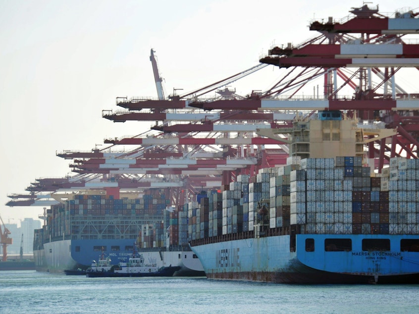 caption: Cargo containers are loaded on ships at a port in Qingdao in China's eastern Shandong province in April. China said it will impose tariffs of 5 percent to 10 percent on $60 billion worth of U.S. products, starting on Monday.
