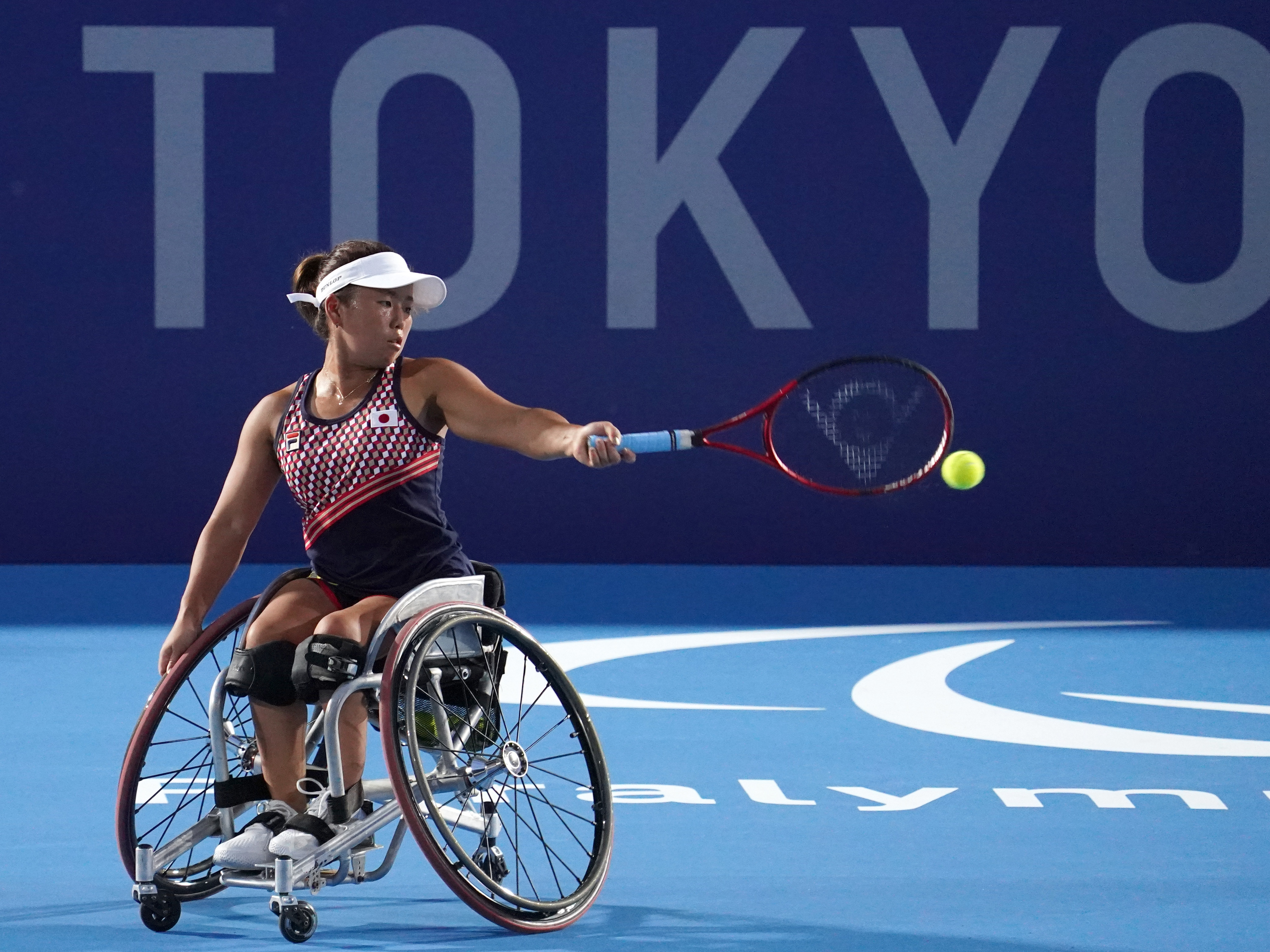 caption: Yui Kamiji of Team Japan in action during a training session ahead of the Tokyo 2020 Paralympic Games at Ariake Tennis Park on August 22, 2021 in Tokyo, Japan.