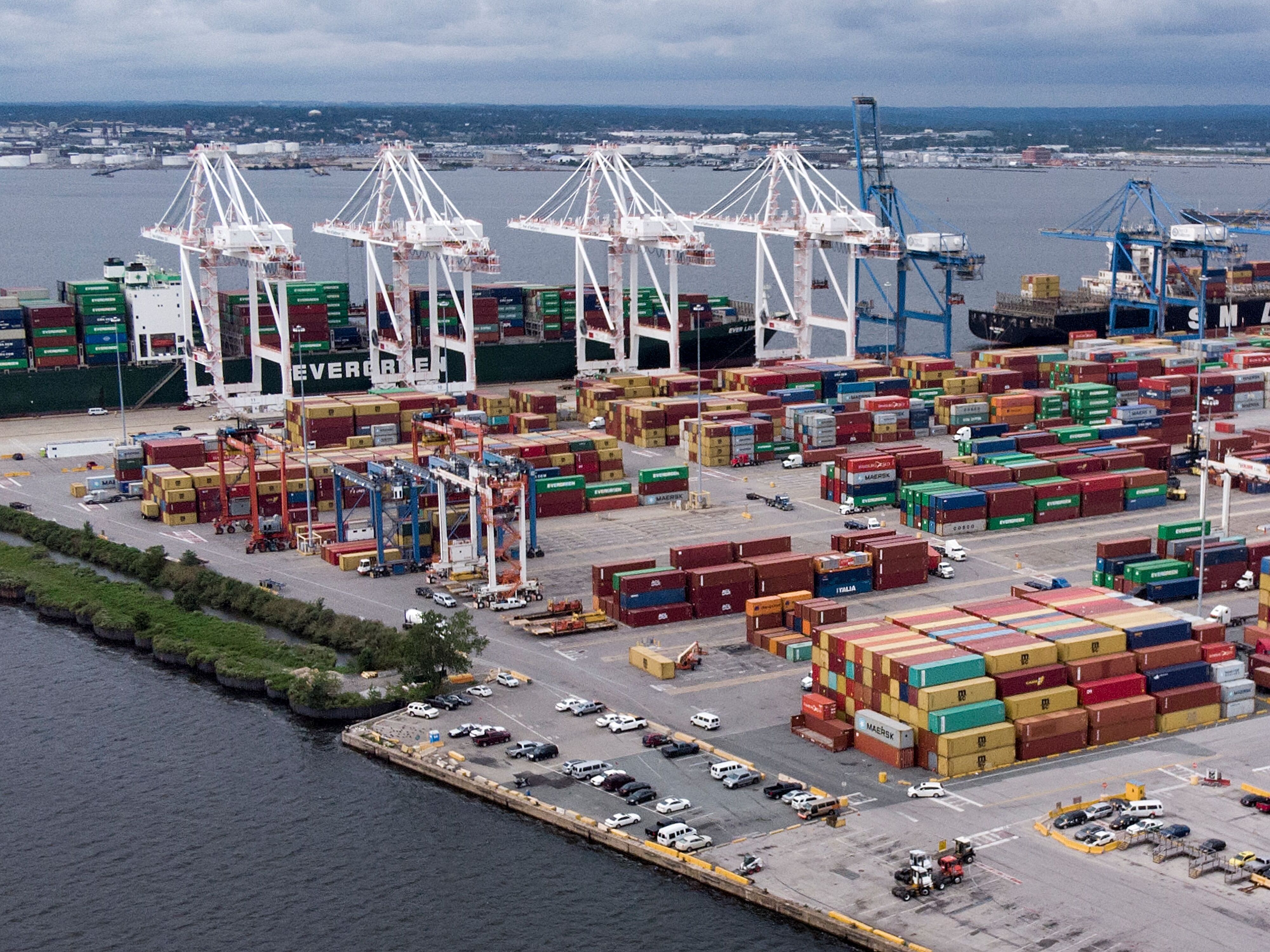 caption: Shipping containers sit piled at the Port of Baltimore on September 21, 2018. Dockworkers on the East Coast and Gulf Coast have threatened to strike as early as October 1, if a new contract deal is not reached.