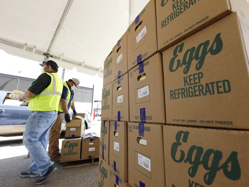 caption: Cases of eggs from Cal-Maine Foods, Inc., await to be handed out by the Mississippi Department of Agriculture and Commerce employees at the Mississippi State Fairgrounds in Jackson, Miss., on Aug. 7, 2020.
