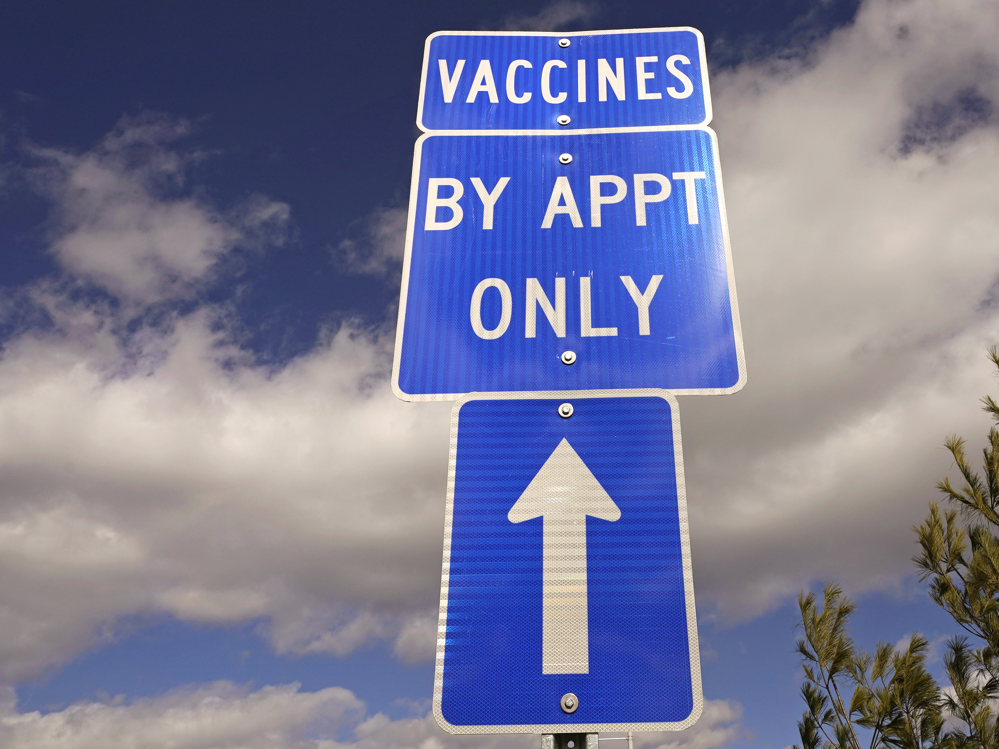 caption: A sign directs motorists to a drive-up COVID-19 vaccine clinic in Exeter, N.H., in February. White House officials announced on Wednesday that a new pilot program will aim to remove common barriers to vaccination for some 2 million seniors from vulnerable communities.