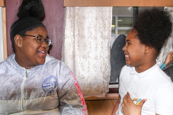 caption: Students in Queen Roshae's Hair Matters class, which is held inside of a mobile salon. (Adora Namigadde/WOSU)