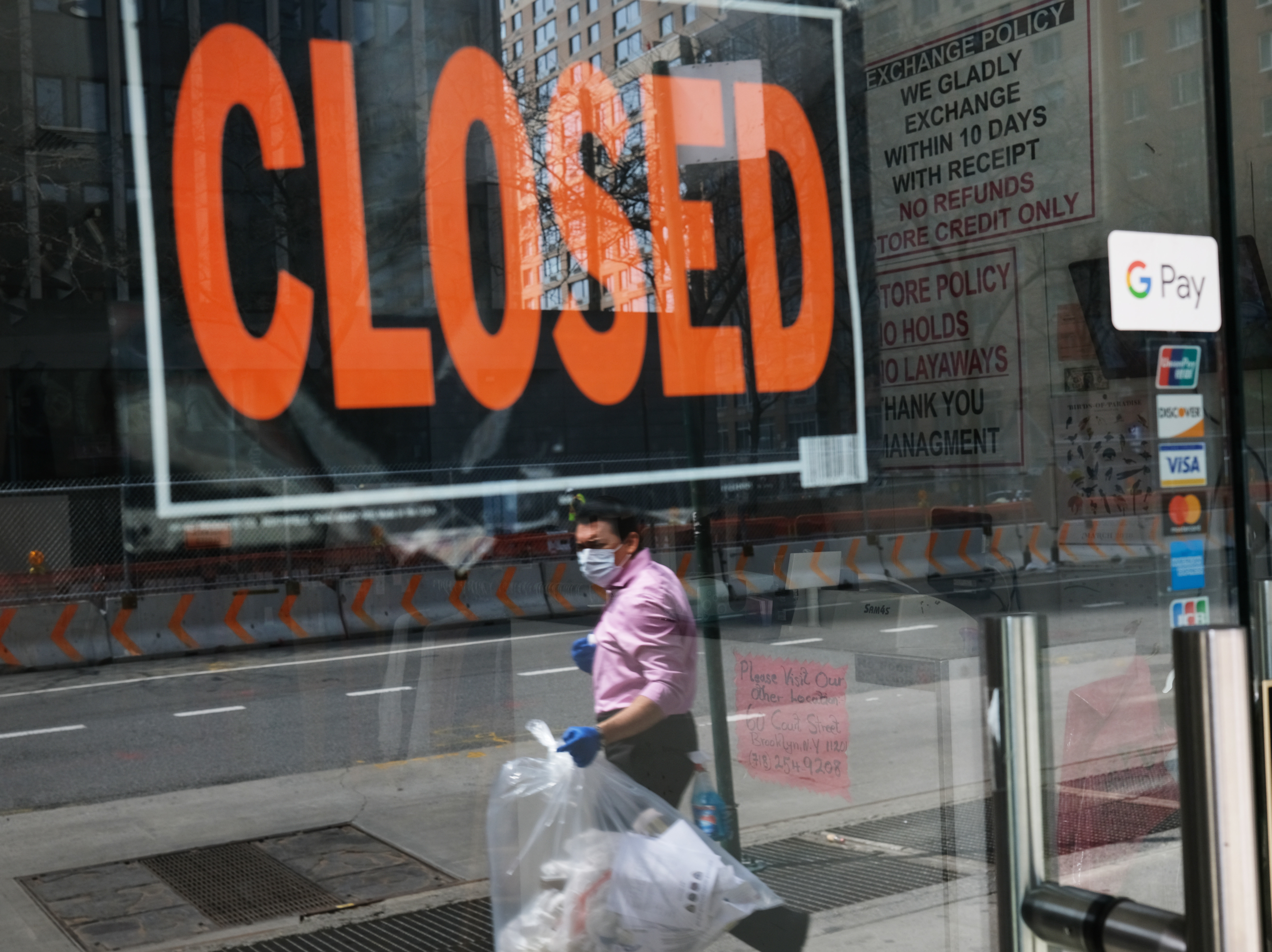 caption: A closed sign is displayed in the window of a business in a nearly deserted lower Manhattan on April 17, 2020, in New York. Many small businesses benefited from a government emergency loan program during the pandemic, but its effectiveness is still in doubt.