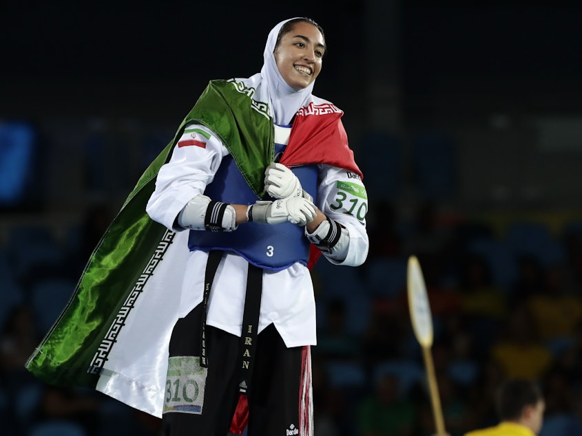 caption: Kimia Alizadeh of Iran celebrates after winning a bronze medal in taekwondo at the 2016 Summer Olympics in Rio de Janeiro, Brazil. She says she is defecting from Iran to escape oppression.