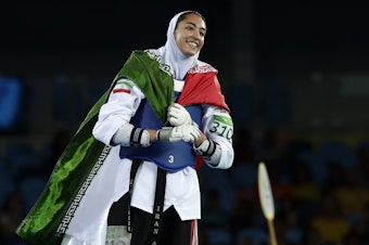 caption: Kimia Alizadeh of Iran celebrates after winning a bronze medal in taekwondo at the 2016 Summer Olympics in Rio de Janeiro, Brazil. She says she is defecting from Iran to escape oppression.