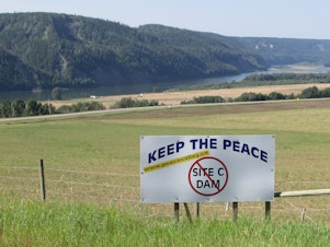 caption: A sign along Highway 29 between Fort St. John and Hudson's Hope, British Columbia, protests the proposed Site C dam. 