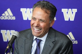 caption: New Washington head coach Jedd Fisch laughs during an NCAA college football press conference to introduce him to the community, Tuesday, Jan. 16, 2024, in Seattle. 