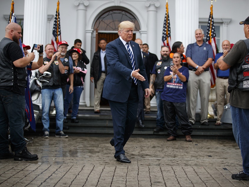caption: President Trump greets supporters in August 2018 at the Trump National Golf Club in Bedminster, N.J. He is fighting several state and congressional efforts to view his tax returns.