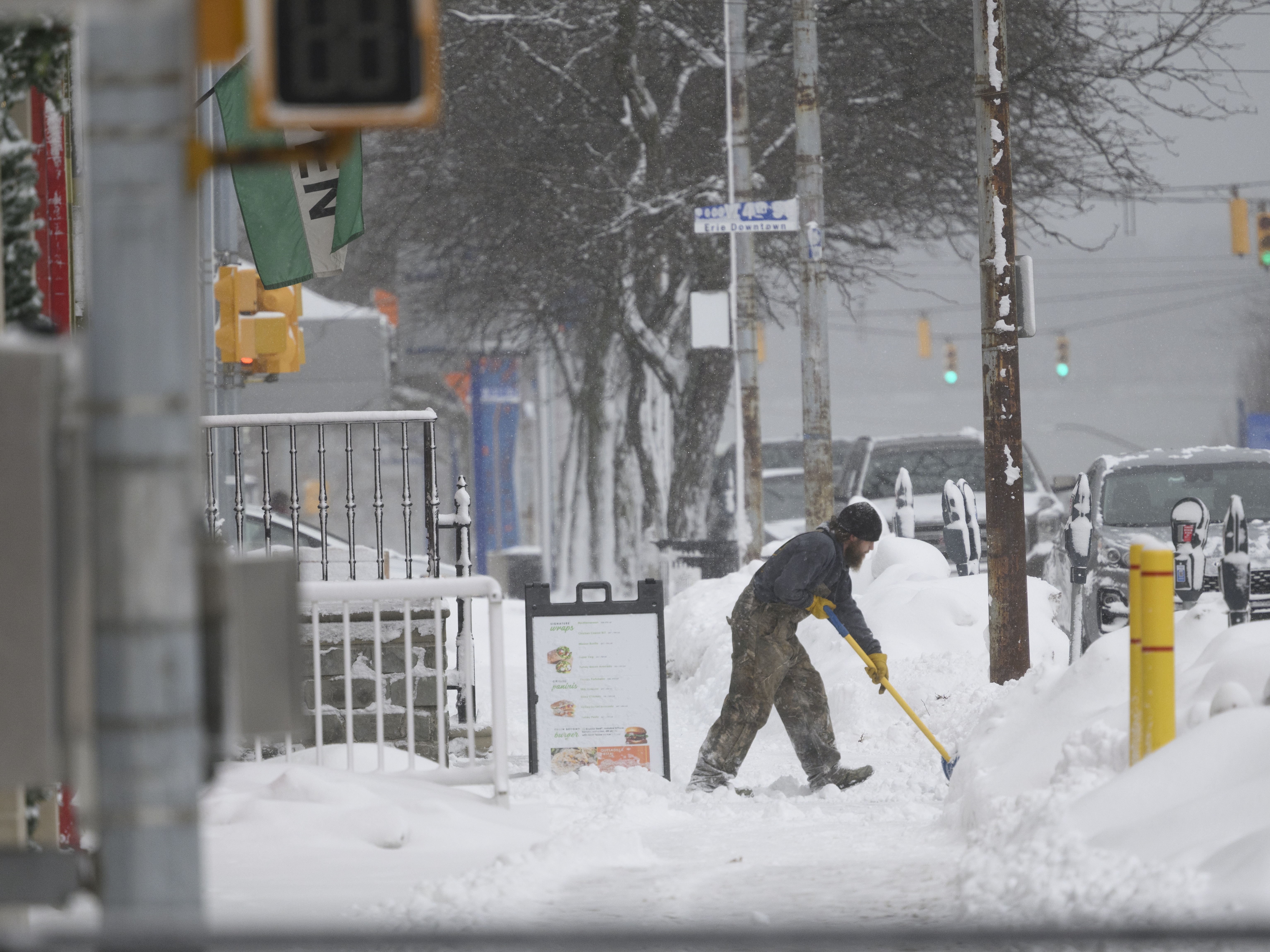 caption: A cold front, combined with a potential lake-effect snow — as seen here in Erie, Pennsylvania in December — could bring freezing temperatures and travel disruptions to much of the central and eastern U.S.