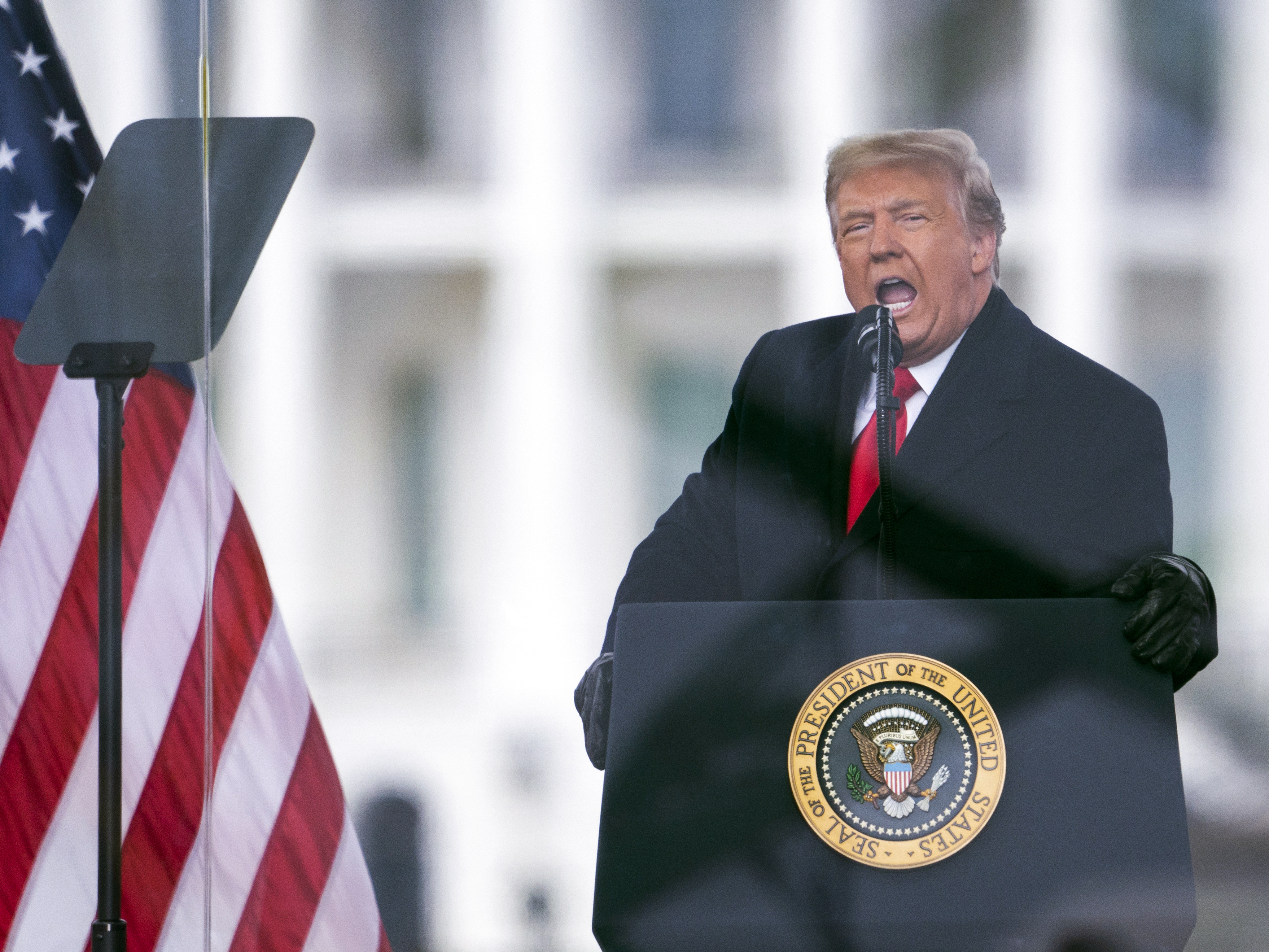 caption: Then-President Donald Trump speaks during a rally protesting the certification of Joe Biden as the next president on Jan. 6, 2021.