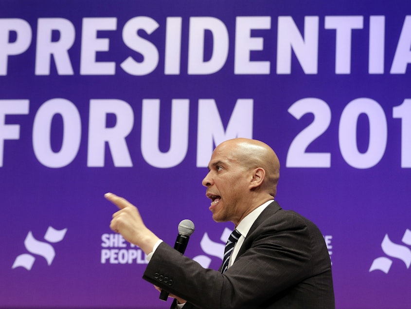 caption: Sen. Cory Booker, D-N.J., answers questions during a presidential forum held by She The People in Houston on Wednesday.