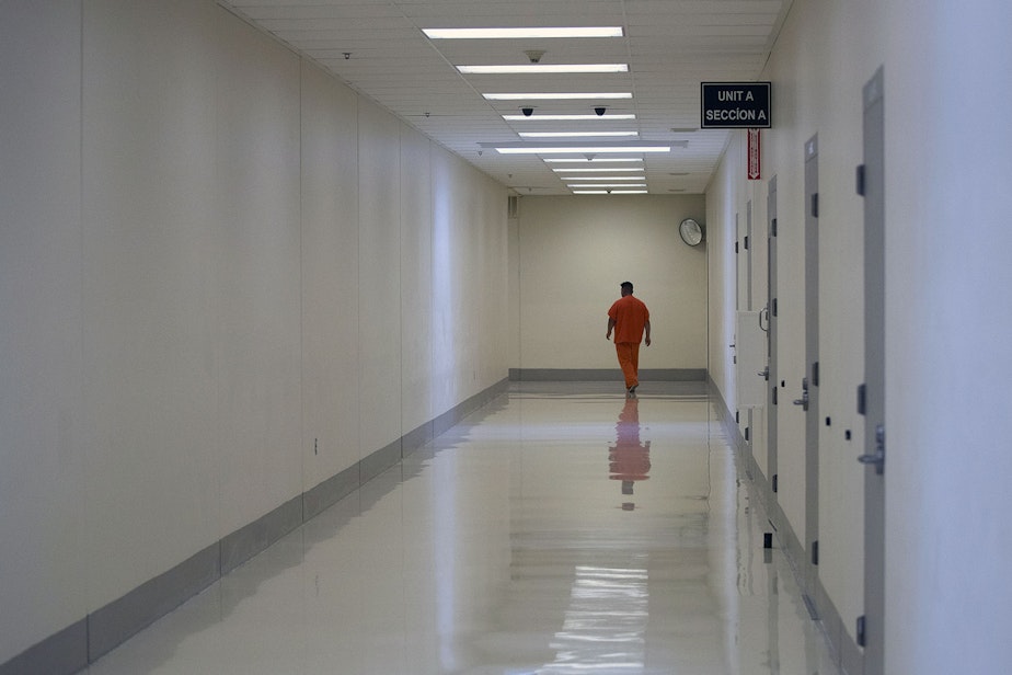 caption: A detainee walks in a hallway on Tuesday, September 10, 2019, at the Northwest Detention Center, recently renamed the Northwest ICE Processing Center, in Tacoma.