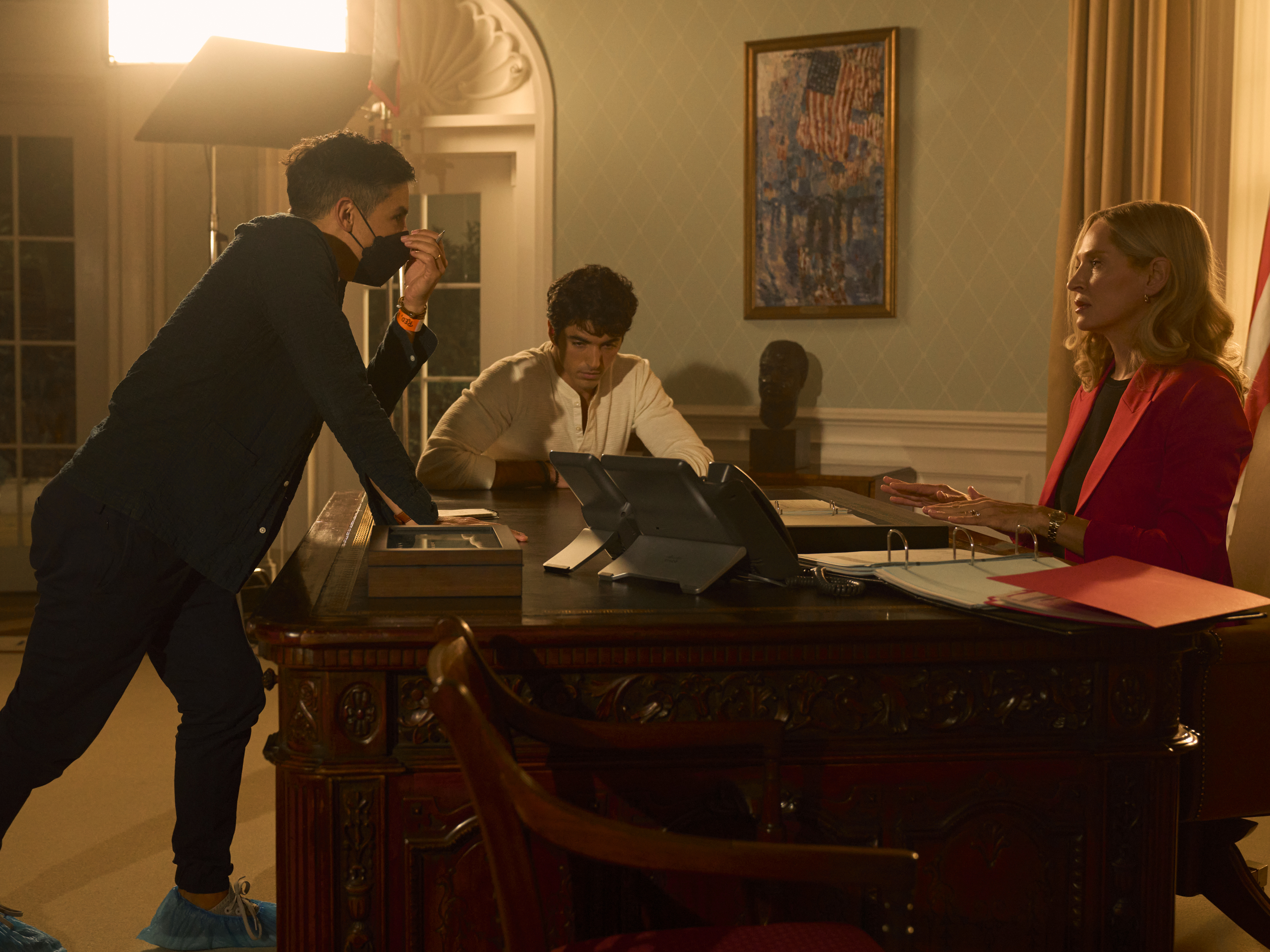 caption: Matthew López (left) on the set of his new movie, <em>Red, White & Royal Blue</em>.