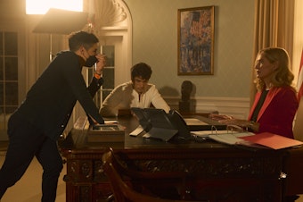 caption: Matthew López (left) on the set of his new movie, <em>Red, White & Royal Blue</em>.