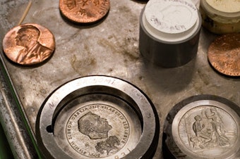 caption: The Nobel Prize gold medal during manufacture at the Swedish Mint. Each laureate receives the medal, which has the likeness of Alfred Nobel on its face.