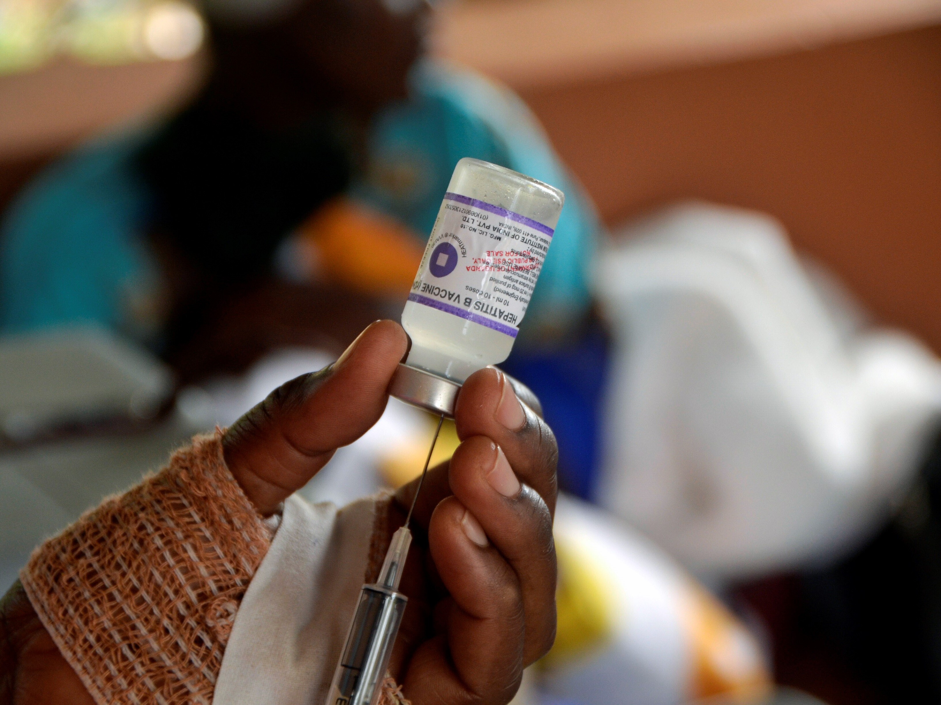 caption: A medical worker prepares a hepatitis B vaccine.