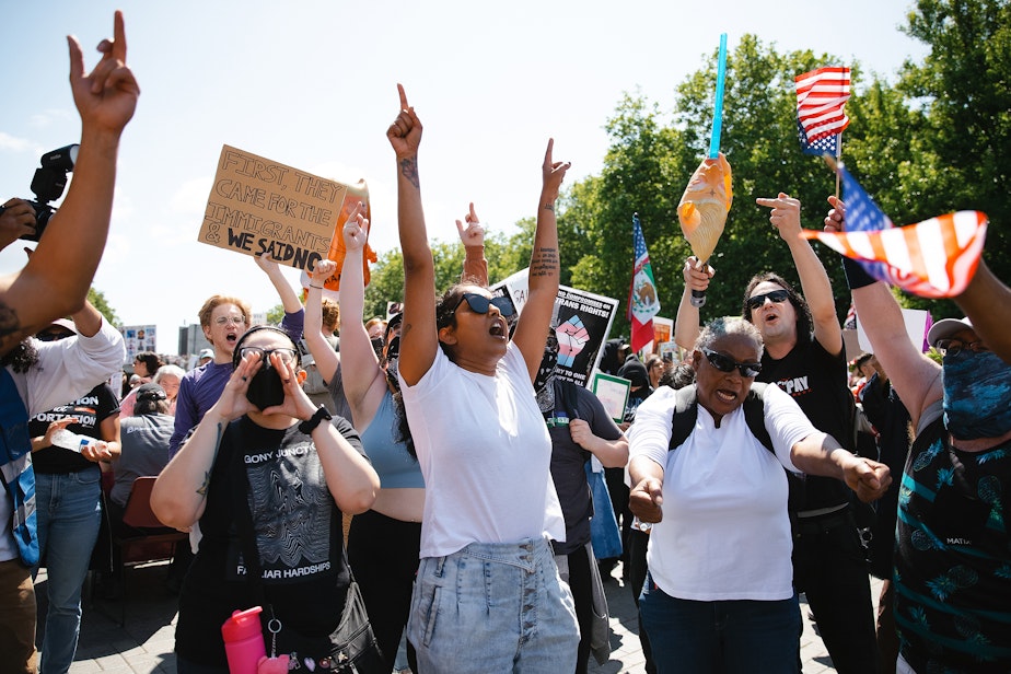 caption: Demonstrators chant together after marching from Cal Anderson Park to Seattle Center on Saturday, June 14, 2025, during the ‘No Kings’ protest in Seattle.