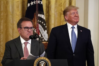 caption: Environmental Protection Agency Administrator Andrew Wheeler and President Trump attend an event about the environment at the White House in July.