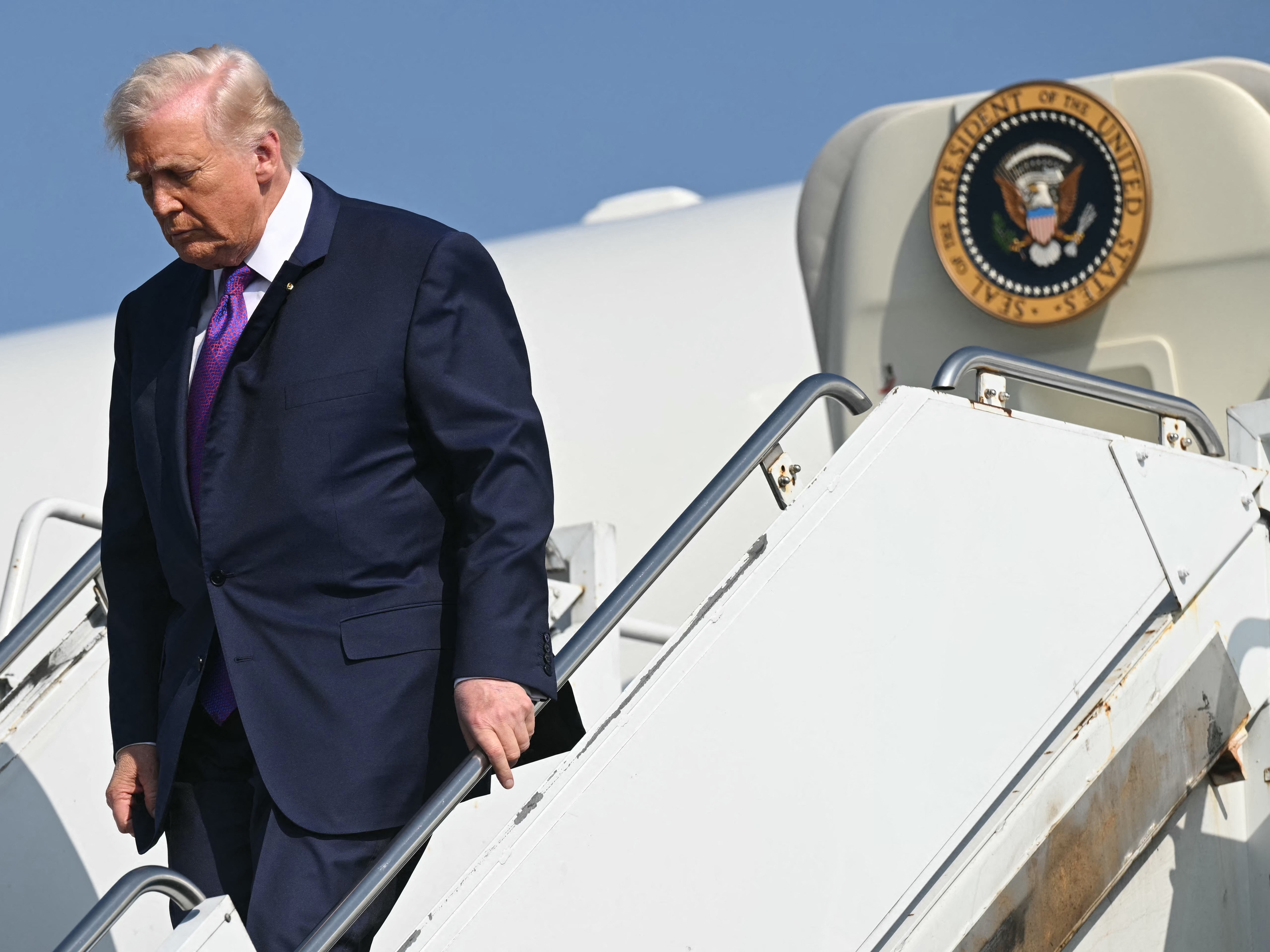 caption: President Trump steps off Air Force One upon arrival in Rome, Ga., on Feb. 19.