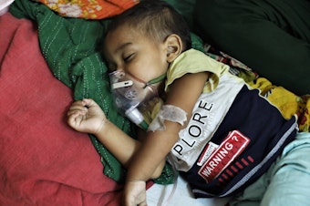 caption: A baby who is suffering from pneumonia receives treatment  at a hospital in Dhaka, Bangladesh on January 13, 2022. A new study points to concerns about childhood deaths after a hospitalization for such diseases as pneumonia, diarrhea and malaria.