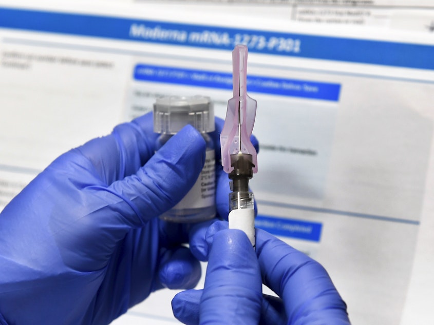 caption: A COVID-19 vaccine developed by Moderna Inc. and the National Institutes of Health, shown here, is one of three vaccines in Phase 3 trials in the U.S. With development and testing underway, health officials are asking states to prepare for limited distribution of a potential vaccine as soon as this fall — though some experts say that's too early.
