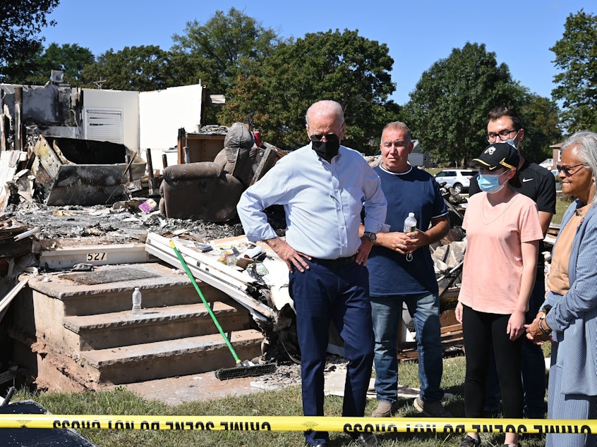 caption: President Biden tours a neighborhood affected by Hurricane Ida in Manville, New Jersey on September 7, 2021.
