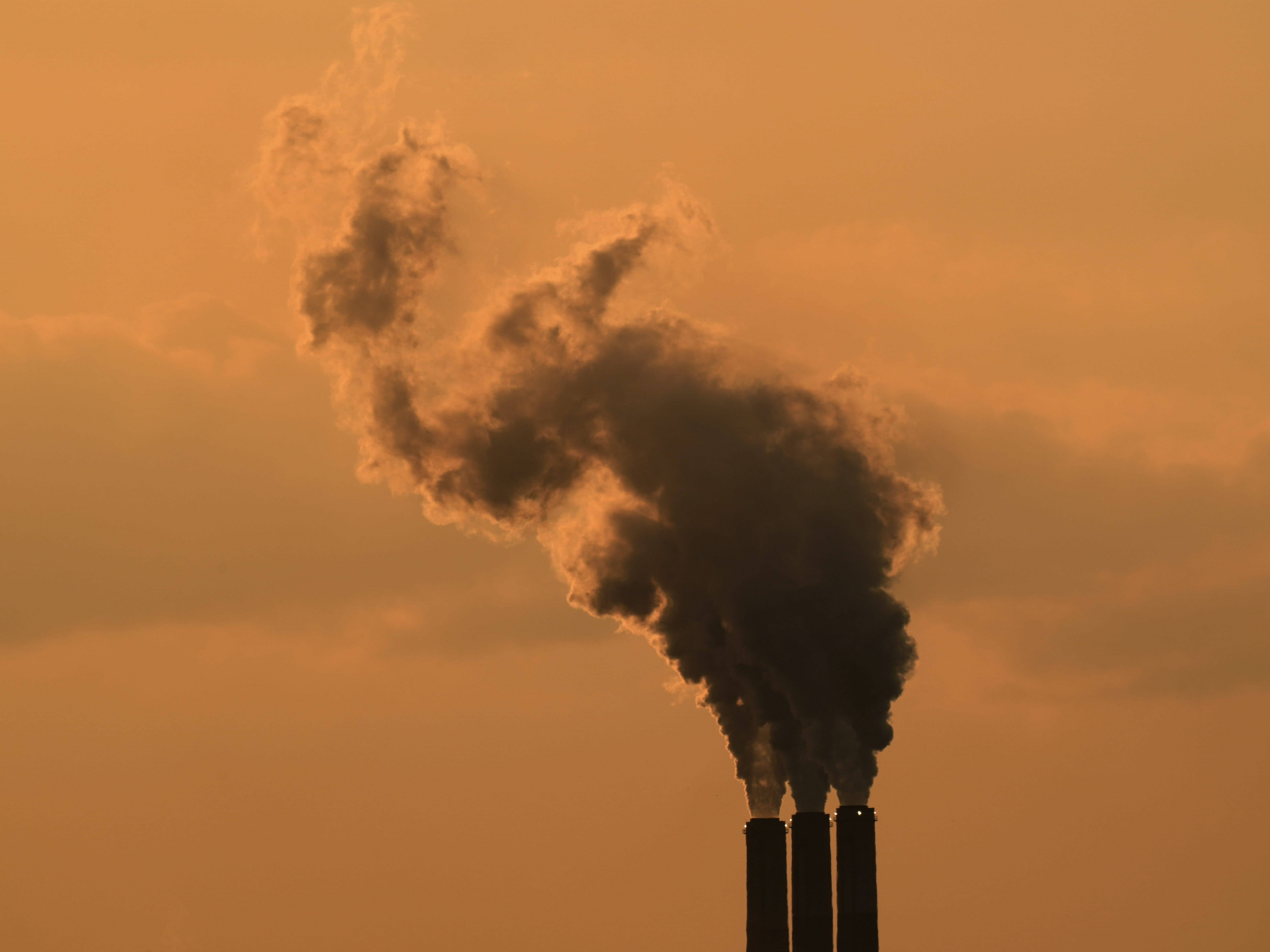 caption: The smokestacks of a coal-fired power plant near Emmet, Kan., in September 2020. Global greenhouse gas emissions continue to rise.