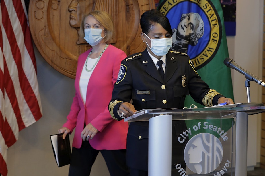 caption: Seattle Police Chief Carmen Best, right, prepares to speak at a news conference as Seattle Mayor Jenny Durkan, left, walks to a socially distanced position, Tuesday, Aug. 11, 2020, in Seattle. Best, the first Black woman to lead Seattle's police department, announced she will be stepping down in September following cuts to her budget that would reduce the department by as many as 100 officers.