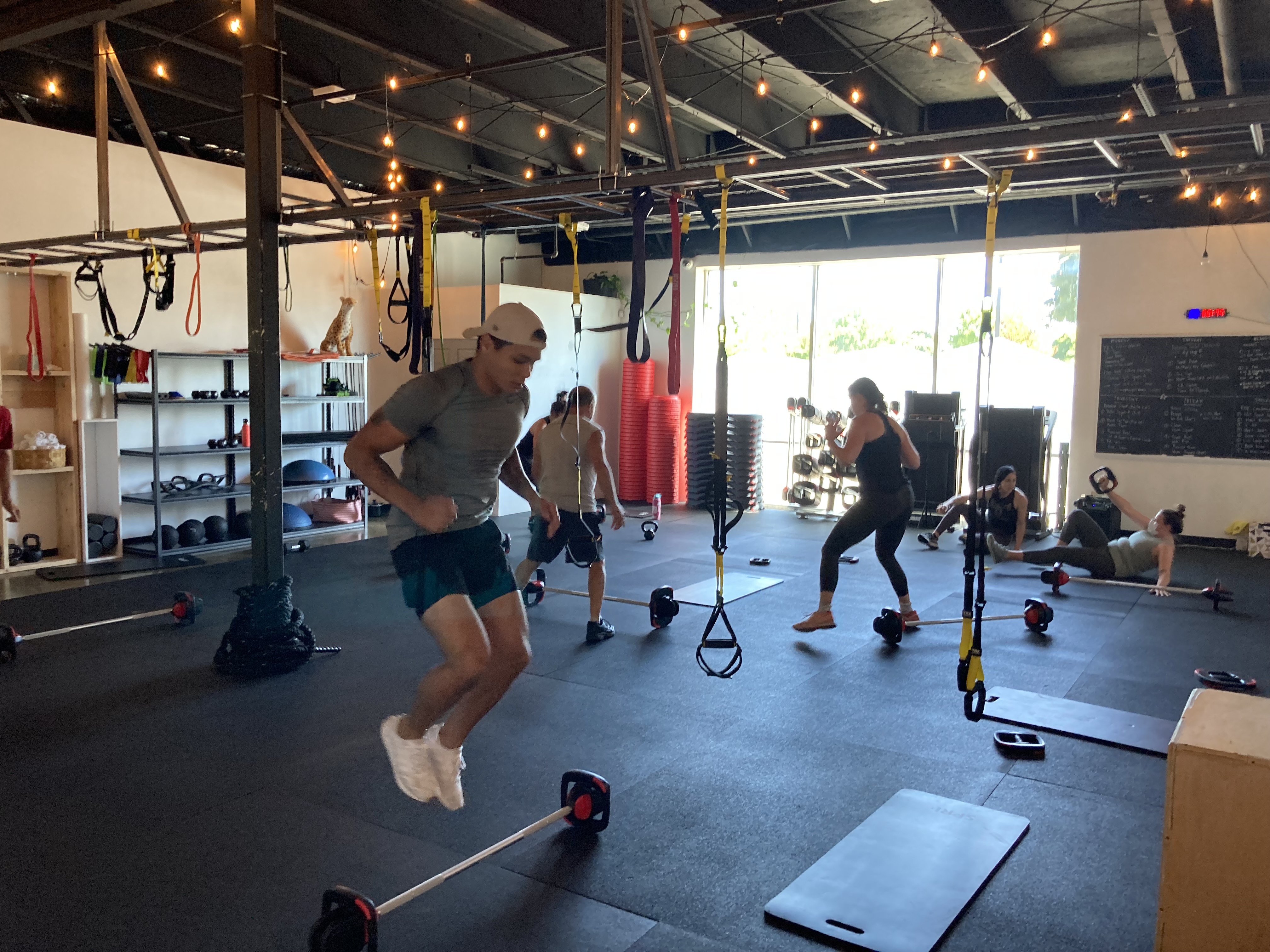 caption: Participants run through a series of exercise circuits during a lunchtime class at Athena Fitness and Wellness in Olympia. The women-owned business opened right before the COVID-19 pandemic struck and survival was never certain. But with the help of grants, loans, a GoFundMe campaign and assistance from their landlord, the owners managed to keep their doors open.