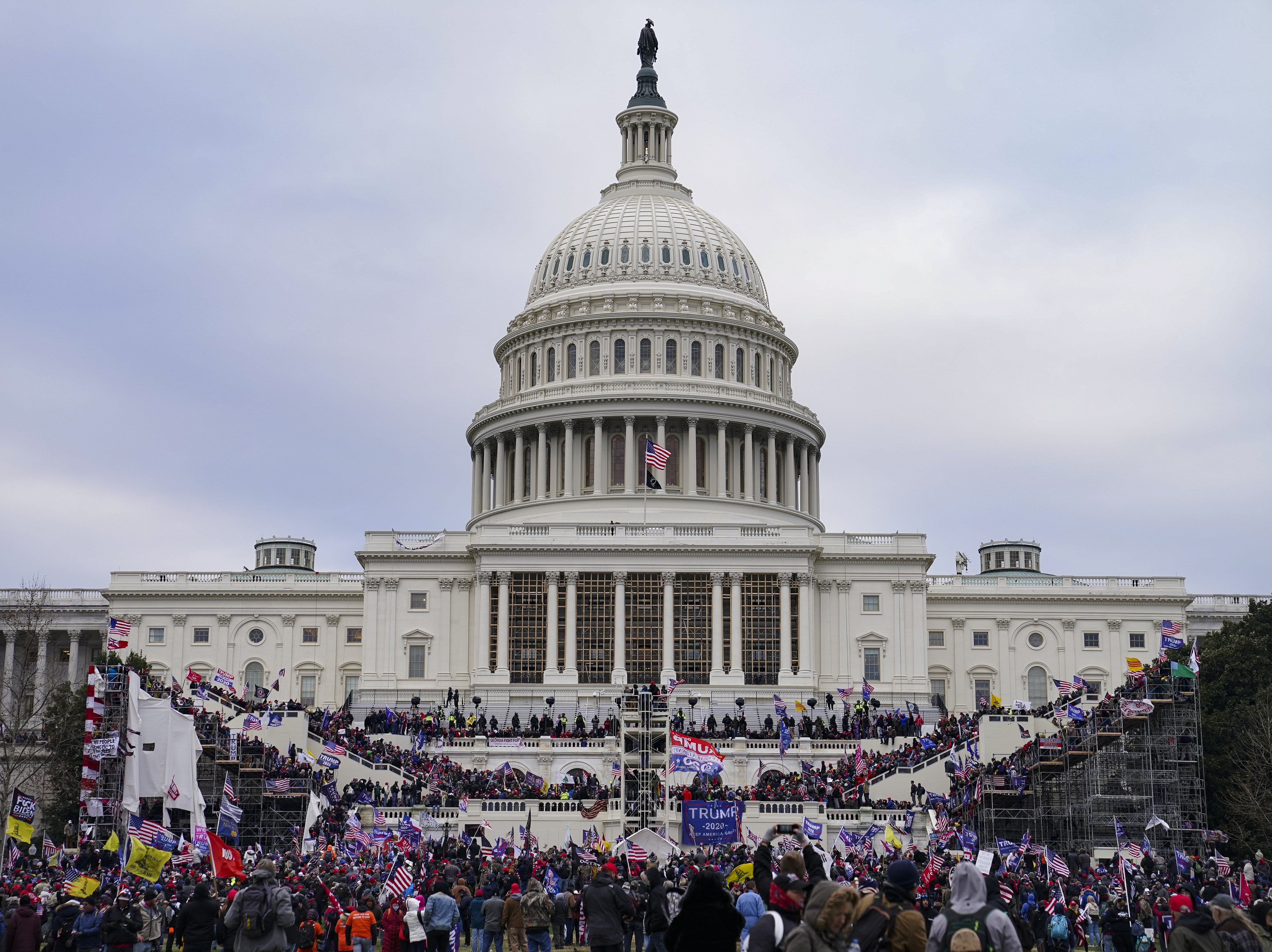 caption: Insurrectionists loyal to President Donald Trump swarm the Capitol on Jan. 6, 2021.