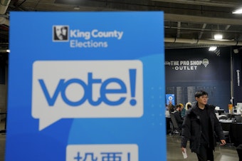 caption: A voter passes by a King County Elections sign at a vote center at Lumen Field on Election Day, Tuesday, Nov. 7, 2023, in Seattle.