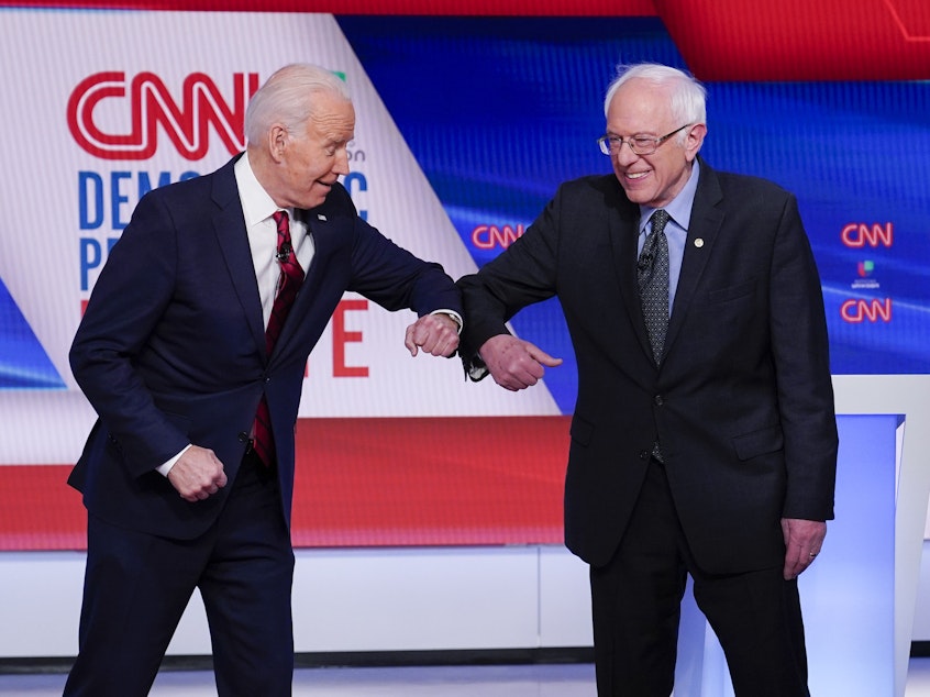 caption: Former Vice President Joe Biden (left) and Sen. Bernie Sanders, I-Vt., greet one another before they participate in a Democratic presidential primary debate.