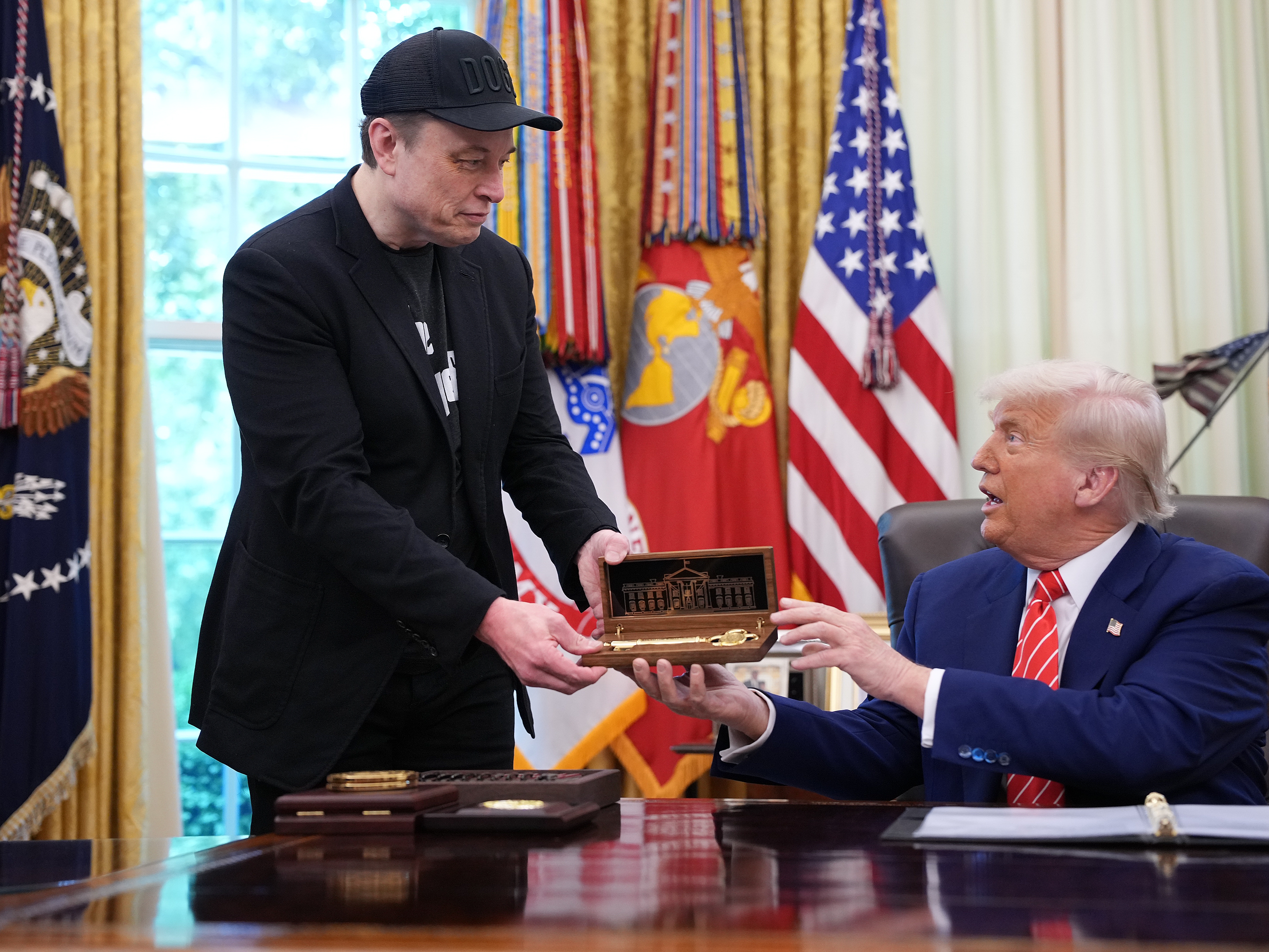 caption: Elon Musk receives a key from President Trump in the Oval Office on May 30, 2025 to thank him for his work with the Department of Government Efficiency. Days later, the pair were feuding online, though Musk has since apologized.