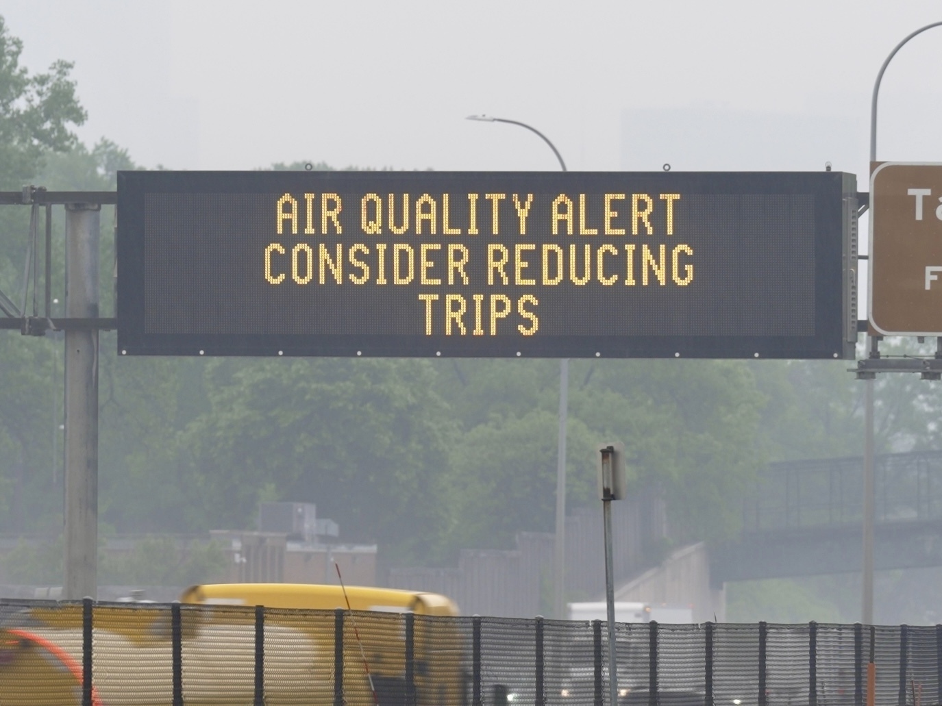 caption: A sign warns of an air quality alert as smoke from wildfires burning in Canada reaches Minneapolis on Tuesday.