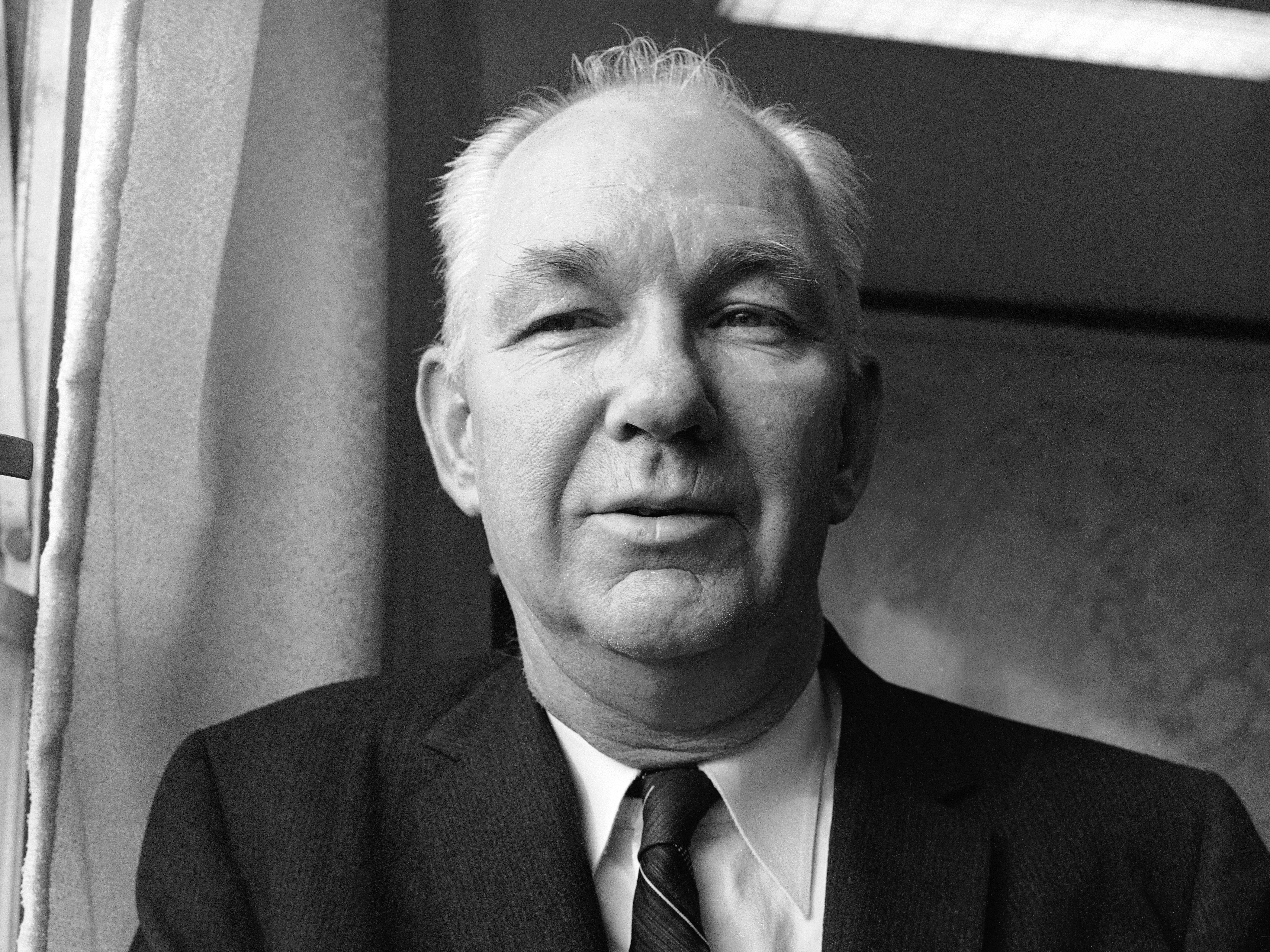 caption: Robert Welch, the founder and head of the John Birch Society, in his Belmont, Mass., office in 1961.
