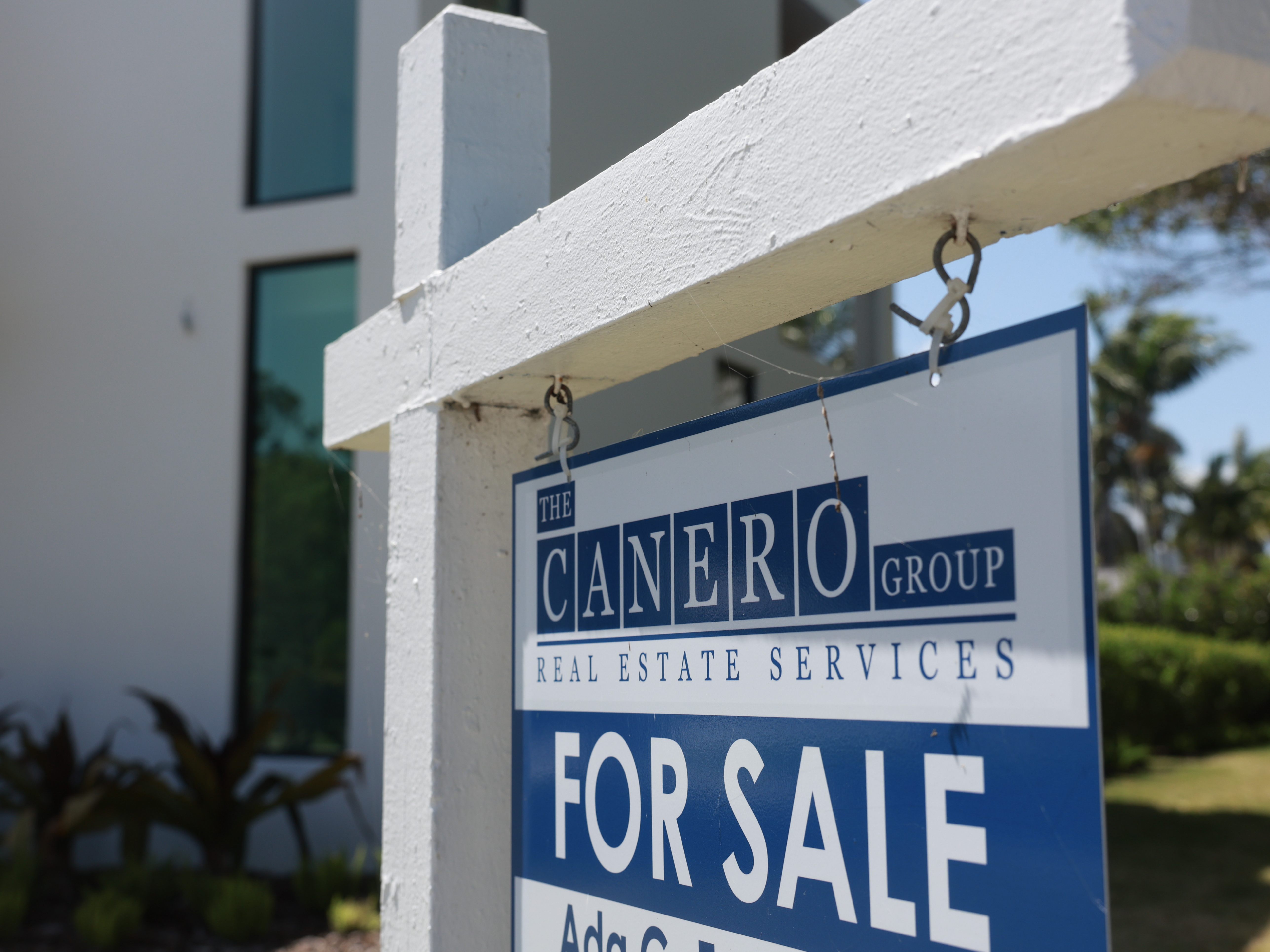 caption: A 'For Sale' sign is posted on the lawn in front of a home on March 15, 2024, in Miami, Fla. The National Association of Realtors announced that it had reached a nationwide $418 settlement of claims that the industry had conspired to keep agent commissions high.