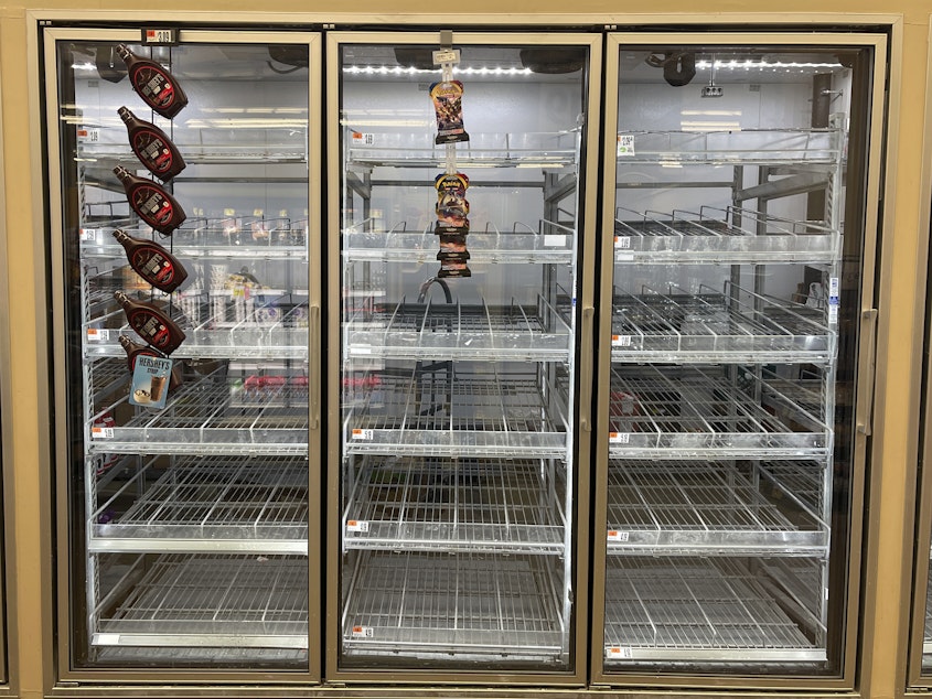 caption: The milk shelf is mostly empty at a Giant grocery store on Tuesday in Washington, D.C.