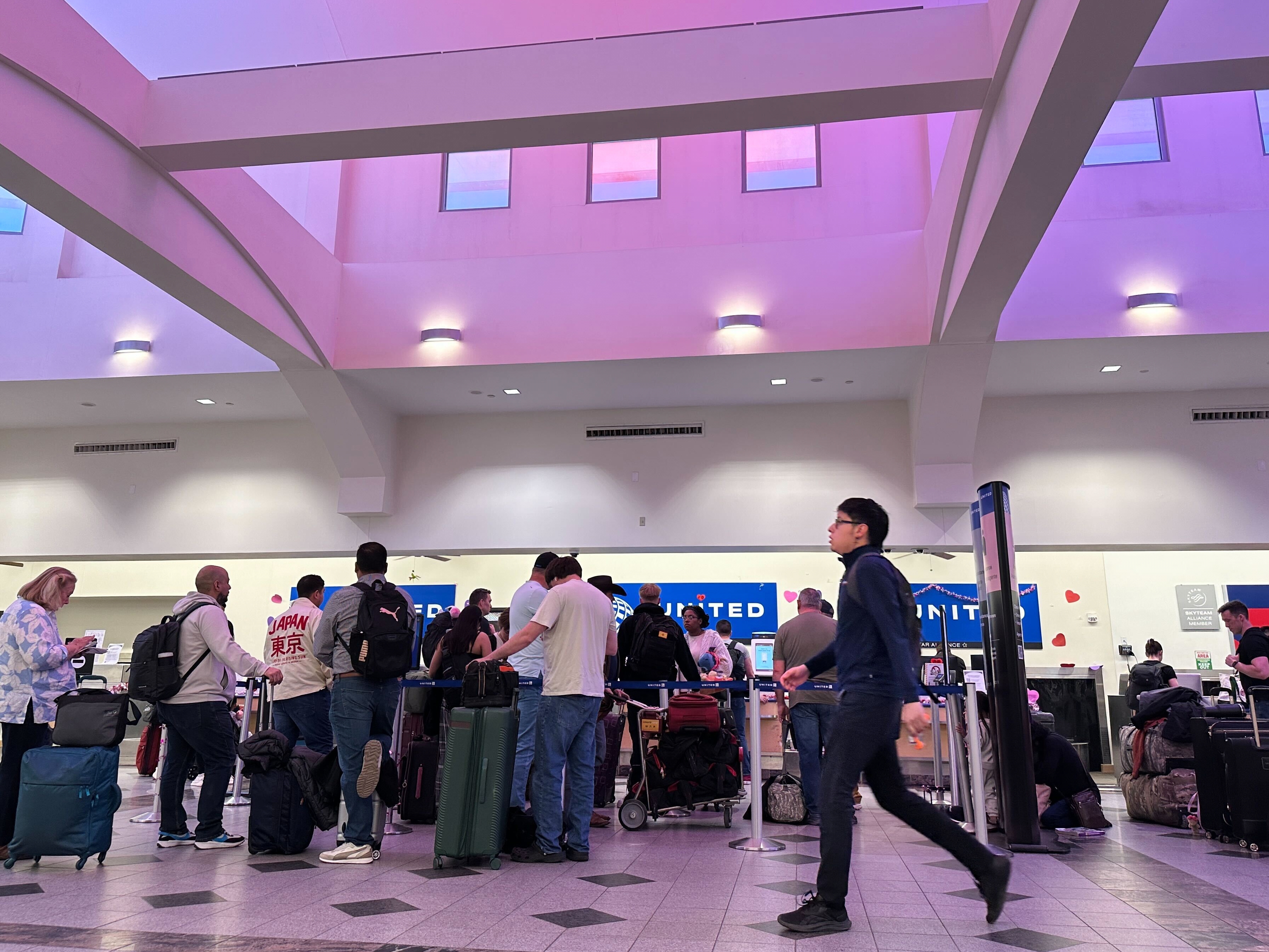 caption: FILE - People stand in line at check-in counters at El Paso International Airport, Wednesday, Feb. 11, 2026, in El Paso, Texas.