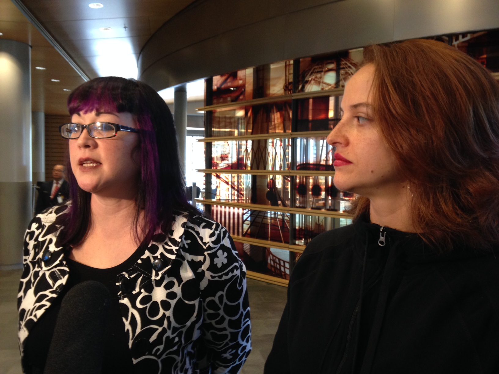 caption: Kathrina Tugadi and Angela Cough of Forward Seattle say $15 minimum wage was chosen at random and their proposal is better.