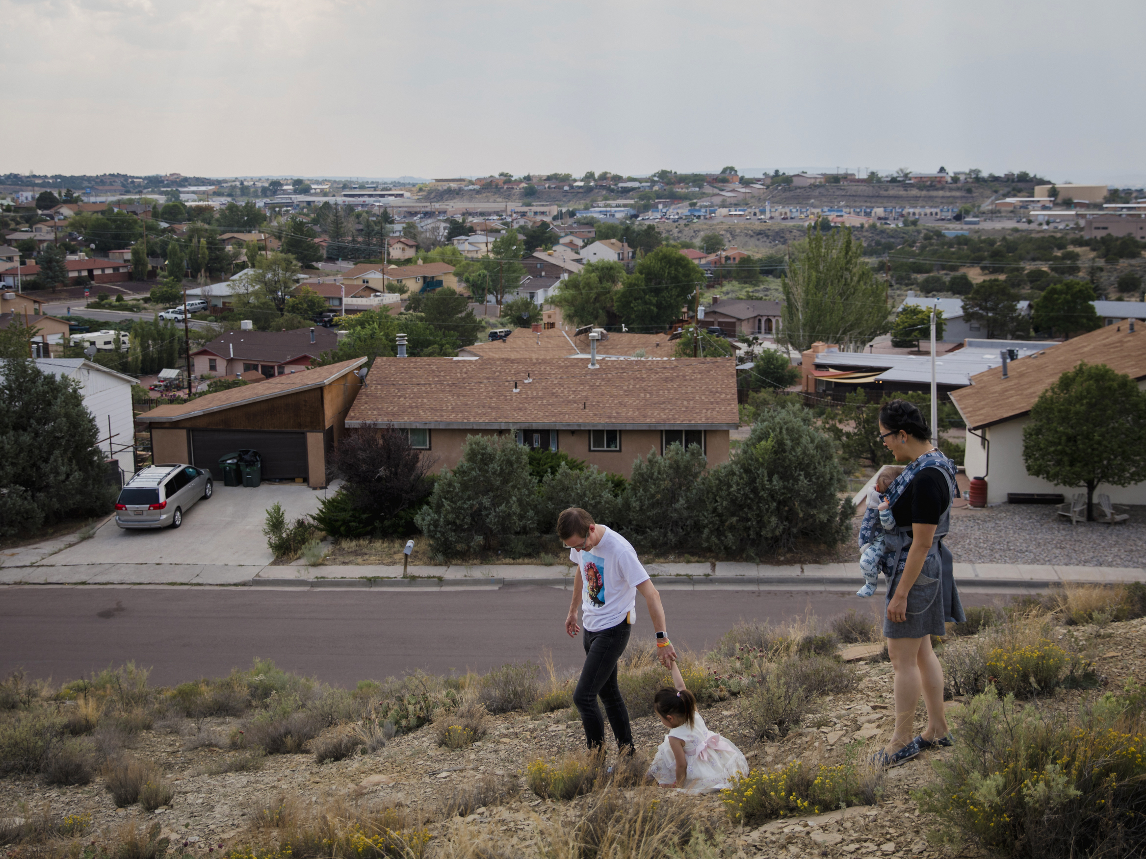 caption: Dr. Chris Hoover (left) and Dr. Connie Liu (right) walk through their home with their children Taro, 3, and Hiro, 4 months, in Gallup, N.M. On a short reporting trip across the Southwest, NPR met very different families and asked them the same simple question: What's been keeping you at night?