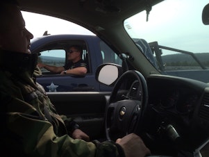 caption: Oregon State Fish and Wildlife troopers James Hayes, left, and Darin Bean patrol several thousand square miles in Central Oregon, where mule deer are in decline. 