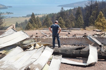 caption: Steve Holett surveys the aftermath of the Elmo 2 Fire at his property, where he had spent the last 18 months building a home.